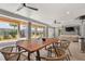 Relaxing covered patio area featuring a large wooden dining table and comfortable seating with ceiling fans at 8067 Jack Island Dr, Johns Island, SC 29455