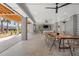 A covered patio features a ceiling fan, heaters, and a dining table with seating at 8067 Jack Island Dr, Johns Island, SC 29455