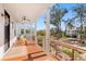 Relax on this charming covered porch with wooden flooring, cable railings, and neighborhood views at 8067 Jack Island Dr, Johns Island, SC 29455