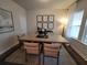 An elegant dining room featuring a natural wood table, neutral chairs, and decorative artwork at 818 Descartes St, Summerville, SC 29486