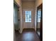 Bright entryway featuring a wood-look floor, white door, and a view to the house across the street at 818 Descartes St, Summerville, SC 29486
