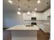 Bright kitchen with white cabinets, a large center island, stainless steel appliances, and modern pendant lighting at 818 Descartes St, Summerville, SC 29486