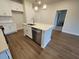 Well-lit kitchen with a stainless steel dishwasher and a spacious island with an undermount sink at 818 Descartes St, Summerville, SC 29486