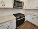 Modern kitchen with stainless steel appliances, white cabinets, quartz countertops, and a herringbone backsplash at 818 Descartes St, Summerville, SC 29486