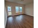 Bright living area with hardwood floors, large windows, and a door leading to the backyard, offering ample space at 818 Descartes St, Summerville, SC 29486