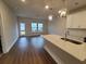 Open-concept kitchen and living area with hardwood floors and ample natural light shining through windows at 818 Descartes St, Summerville, SC 29486