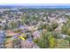 An aerial view of the home in a quiet neighborhood with water views in the distance at 847 Quail Dr, Charleston, SC 29412