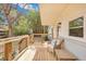 Charming back porch with wooden railing, comfortable seating, and a view of the lush backyard at 847 Quail Dr, Charleston, SC 29412