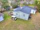 A light-grey single-Gathering home with a golf cart sits on a spacious lawn and a wooden deck at 847 Quail Dr, Charleston, SC 29412
