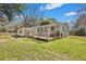 Backyard view highlighting a wood deck with built-in benches and wood railing at 847 Quail Dr, Charleston, SC 29412