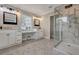 Spacious bathroom featuring dual vanities, a makeup area, and a modern glass-enclosed shower, offering luxury and convenience at 847 Quail Dr, Charleston, SC 29412