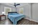 Light-filled bedroom with large windows, a comfortable bed, and stylish floors, perfect for relaxation at 847 Quail Dr, Charleston, SC 29412