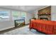 Bedroom with brick fireplace, wood floors, an area rug, and three windows at 847 Quail Dr, Charleston, SC 29412