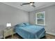 Bedroom with a blue comforter set, hardwood floors, and a nightstand with lamp at 847 Quail Dr, Charleston, SC 29412