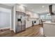 Bright kitchen featuring stainless steel appliances, white cabinets, and wood-look floors at 847 Quail Dr, Charleston, SC 29412
