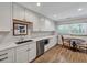 Bright kitchen with stainless appliances, white cabinets, and a cozy breakfast nook at 847 Quail Dr, Charleston, SC 29412
