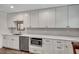 Bright kitchen featuring stainless appliances, white cabinets, and a breakfast bar at 847 Quail Dr, Charleston, SC 29412