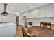 Bright kitchen features white cabinets, stainless appliances, stone countertops, and breakfast table at 847 Quail Dr, Charleston, SC 29412