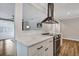 Kitchen bar with a view to the living room and stainless steel range hood at 847 Quail Dr, Charleston, SC 29412