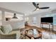 Bright living room boasts a ceiling fan, hardwood floors, and a view into the modern kitchen at 847 Quail Dr, Charleston, SC 29412