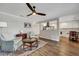 Bright living room boasts a ceiling fan, hardwood floors, and a view into the modern kitchen at 847 Quail Dr, Charleston, SC 29412