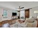 Bright living room boasts a ceiling fan, hardwood floors, and rustic barn doors at 847 Quail Dr, Charleston, SC 29412