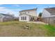 Large fenced backyard showing the house with patio, fire pit and grassy area at 9000 Hema Ln, Summerville, SC 29483