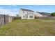 Fenced backyard showing a two-story home, patio and green space at 9000 Hema Ln, Summerville, SC 29483
