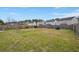 Spacious backyard featuring a large grassy area and a wooden fence, offering privacy and room for outdoor activities at 9000 Hema Ln, Summerville, SC 29483