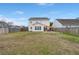 Large fenced backyard with patio, fire pit and a view of the two-story home at 9000 Hema Ln, Summerville, SC 29483