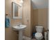 Cozy half bathroom featuring a classic pedestal sink, framed mirror, and a standard toilet at 9000 Hema Ln, Summerville, SC 29483