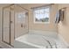 Bright bathroom featuring a soaking tub and glass enclosed shower near a window at 9000 Hema Ln, Summerville, SC 29483