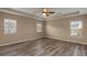 Spacious bedroom with hardwood floors, ample natural light, and a tray ceiling at 9000 Hema Ln, Summerville, SC 29483