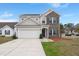Charming two-story home with a brick and siding facade, well-manicured lawn, and a two-car attached garage at 9000 Hema Ln, Summerville, SC 29483