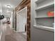 Hallway with wood accent wall, showcasing the home's unique architectural details and a convenient built-in shelving unit at 9000 Hema Ln, Summerville, SC 29483