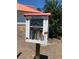 Community little library with glass door and red trim and gabled roof on a post at 9000 Hema Ln, Summerville, SC 29483