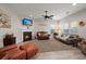 Spacious living room featuring an electric fireplace, ample seating, and a ceiling fan at 9000 Hema Ln, Summerville, SC 29483