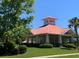 Community pool pavilion featuring red roof and white columns in a lush green setting at 9000 Hema Ln, Summerville, SC 29483