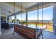 Relaxing porch swing with views of the coastline, pool, and ocean at 939 White Point Blvd, Charleston, SC 29412