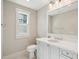 Bright bathroom features a modern vanity, framed mirror, and natural light from the window at 939 White Point Blvd, Charleston, SC 29412