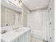 Well-lit bathroom with a large vanity, subway tiled shower, and modern fixtures at 939 White Point Blvd, Charleston, SC 29412