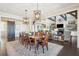Open dining room and living room with hardwood floors, modern lighting, and neutral color scheme at 939 White Point Blvd, Charleston, SC 29412