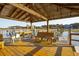 Covered dock featuring a wooden bench offering relaxing waterfront views and direct access to the water at 939 White Point Blvd, Charleston, SC 29412