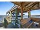 View of dock featuring boat lift with boat, bench seating, and views of the water at 939 White Point Blvd, Charleston, SC 29412
