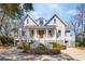 Stately two-story home featuring a welcoming front porch, beautiful landscaping, and a circular driveway at 939 White Point Blvd, Charleston, SC 29412