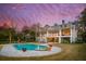 Luxury home with a pool, outdoor seating, and manicured landscaping creating a serene waterfront retreat at 939 White Point Blvd, Charleston, SC 29412