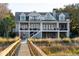 Stately gray home featuring multiple balconies, a dock, and access to scenic waterfront views at 939 White Point Blvd, Charleston, SC 29412