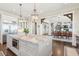 View of kitchen with island, stainless appliances, and an open layout to living and dining areas at 939 White Point Blvd, Charleston, SC 29412