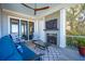 Outdoor porch features fireplace, seating, ceiling fan, and views of the landscaping at 939 White Point Blvd, Charleston, SC 29412