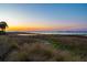 Picturesque waterfront view featuring marsh grasses with the cityscape silhouetted in the sunset at 939 White Point Blvd, Charleston, SC 29412